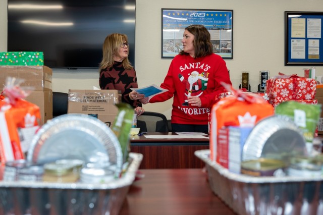 In preparation for distribution, Connie Porterfield, U.S. Army Garrison Fort Leonard Wood executive officer and Jennifer Reinke, a management analyst for the Directorate of Resource Management, organize the Garrison Gives donations Dec. 18 in Hoge...