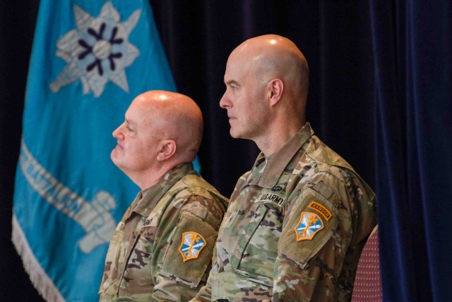 Brig. Gen. Rhett R. Cox, right, the commanding general of Army Counterintelligence Command, listens to remarks beside incoming Command Chief Warrant Officer Jamie Turner at the command chief warrant officer change of responsibility ceremony at...