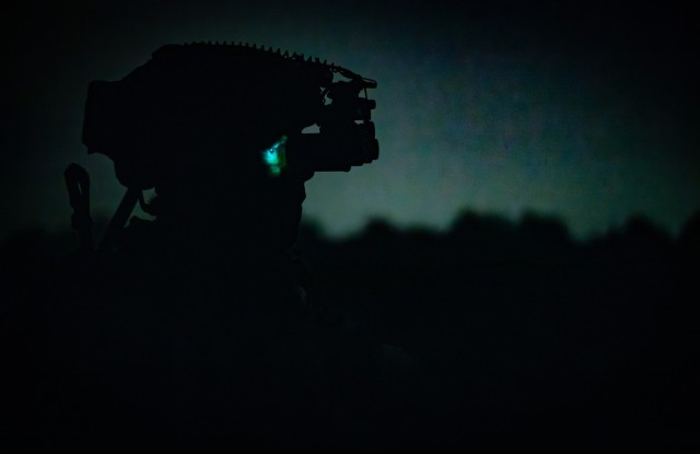 A U.S. Army Paratrooper assigned to the 82nd Airborne Division looks through a night vision device as he directs supporting fire during the Division&#39;s first multi-domain live fire exercise on Fort Liberty, North Carolina, May 7, 2024.