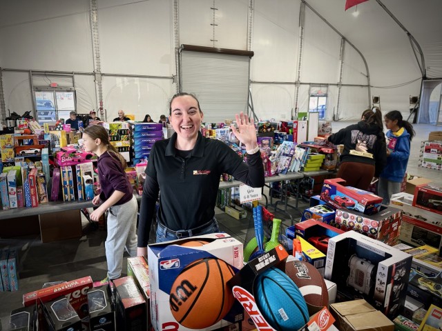 A Fort Irwin Community Volunteer helps to distribute thousands of donated toys collected by The High Desert Mopars Car Club January 11th, 2025 for &#34;Christmas in January.&#34; The club collects donations while participating in Southern...