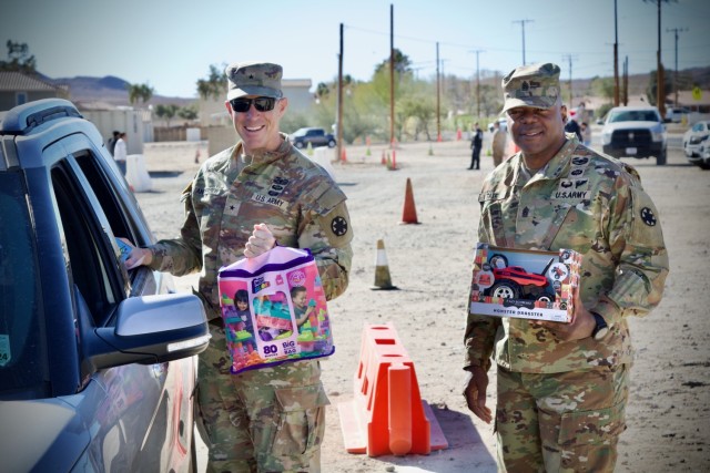 Fort Irwin&#39;s Command Team, Brig. Gen. Brandon C. Anderson and Command Sgt. Maj. Carvet C. Tate  volunteer to distribute thousands of donated toys collected by The High Desert Mopars Car Club January 11th, 2025 for &#34;Christmas in...