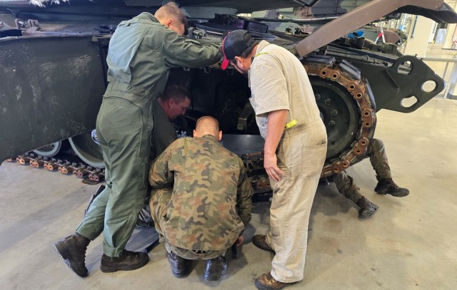 A representative from U.S. Army Tank-automotive and Armaments Command (right) provides instruction to Poland Provided Logistic Support personnel from the Polish military’s 33rd Army Prepositioned Stocks Battalion on maintenance of the M1A2 SEPv3...