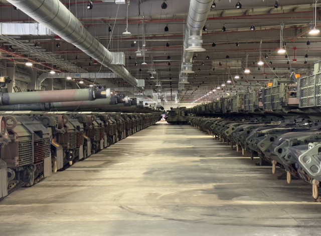 A line of M1A2 SEPv3 Abrams main battle tanks are stored at the Powidz Army Prepositioned Stocks-2 worksite in Powidz, Poland. Powidz APS-2 is the NATO-funded worksite and the U.S. Army’s newest, most modern APS worksite in the world. Army Field...