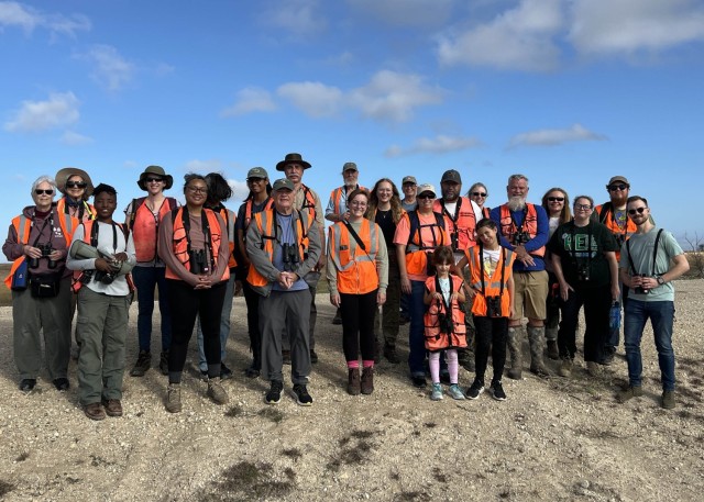 A group of people standing close together pose for a photo. 