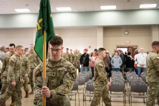 U.S. Army Spc. Tyler Pettibone, of the 617th Military Police Company, 149th Maneuver Enhancement Brigade, places the guidon at the deployment ceremony at the Armed Forces Reserve Center in Richmond, Kentucky, Jan. 4, 2025. Approximately 40 Soldiers with the 617th are deploying to the Middle East to support Operation Inherent Resolve. (U.S. Army National Guard photo by Andy Dickson)