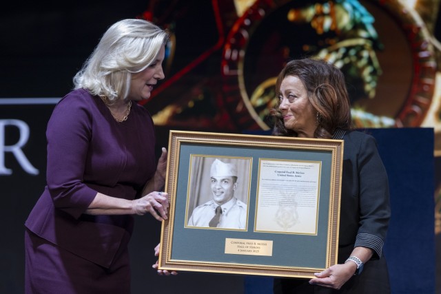 Secretary of the Army Christine E. Wormuth presents a framed Medal of Honor citation to Victoria Secrest, daughter of Medal of Honor Recipient Army Cpl. Fred McGee, at a Medal of Honor Hall of Heroes Induction ceremony in Conmy Hall on Joint Base Myer-Henderson, Arlington, Va., Jan. 5, 2025 (DoD photo by U.S. Navy Petty Officer 1st Class Alexander Kubitza)