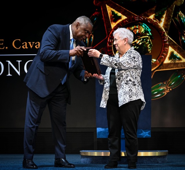 Laura Blevins, center, daughter of former Army Gen. Richard Cavazos, receives a framed Medal of Honor flag from Secretary of Defense Lloyd J. Austin during the Hall of Heroes Induction Ceremony in Conmy Hall at Joint Base Myer-Henderson Hall, Va., on Jan. 4th, 2025. Cavazos – who later achieved the distinction of becoming the U.S. Army’s first Hispanic four-star general – was posthumously awarded the Medal of Honor at the White House, Jan. 3, 2025, for his acts of extraordinary heroism during the Korean War on June 14, 1953, near Sagimak, Korea, while serving in Echo Company, 2nd Battalion, 65th Infantry Regiment. (U.S. Army Photo by Staff Sgt. Derek Hamilton)