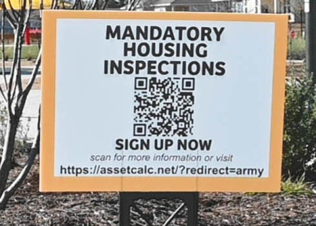 A sign sitting staked in the ground reads &#34;MANDATORY HOUSING INSPECTIONS&#34; with a QR code and a url underneath.&#34;