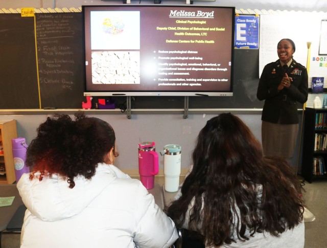 Soldier Lt. Col. Melissa Munro Boyd gives a presentation in front of high school students.