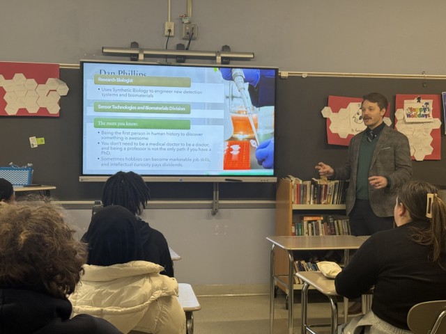 Daniel Phillips gives a presentation in front of high school students.