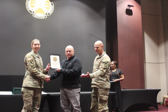 Scott Throckmorton receives a 35 years Length of Service Award during the Garrison quarterly awards ceremony Friday in Bob Jones Auditorium. From left are Garrison Commander Col. Erin Eike, Throckmorton and Command Sgt. Maj. John Fritz....