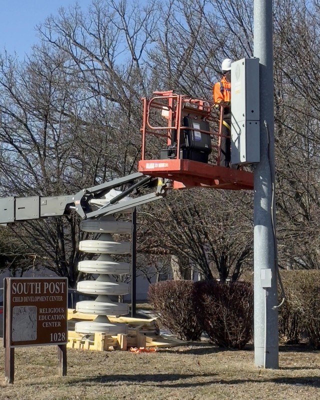 A crew on Fort Belvoir's 12th Street installs a new speaker and control system for the giant voting system of the installation, January 28. The new system will allow more specific alarms to be loaded for immediate use that warns them near possible ...