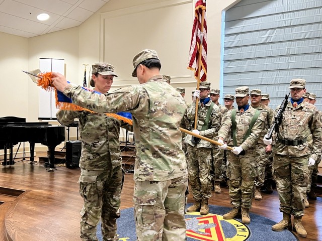 Lt. Col. Lindsay Ryan (left) and Sgt. Maj. Carlos Silva (right) of the 1st Battalion, 58th Aviation Regiment prepare the unit colors for casing during the casing of the colors ceremony inside Wings Chapel at Fort Novosel, 10 Jan. 2025. The casing...