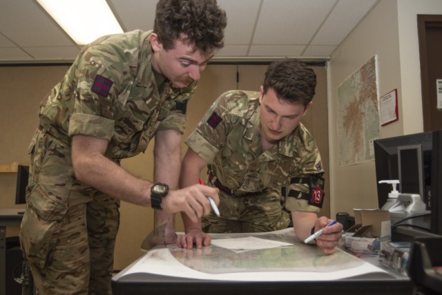 British Lance Cpl. Jonathan Ward (right) and Sapper George Gibbons, from Royal Air Force Station Wyton, map a safe convoy route under time constraints in Brown Hall during the U.S. Army Engineer School’s Regimental Best Mapper Competition, which...