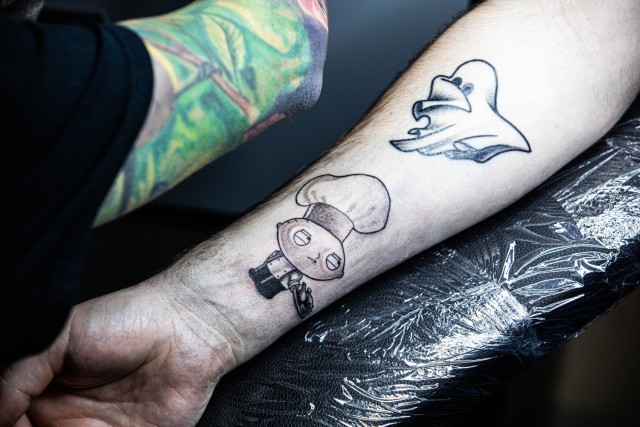 Kinga Nemeth, Infamous Ink tattoo artist, gives a tattoo to a customer during a grand opening event at Fort Stewart, Georgia, Jan. 31. Infamous Ink is open seven days a week from 11 a.m. to 6 p.m., and is located next to the Commissary on base....