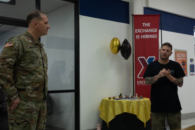 Col. Marc J. Austin, the garrison commander of Fort Stewart-Hunter Army Airfield, left, talks about the grand opening of Infamous Ink with the owner, Chris Schiavi, at Fort Stewart, Georgia, Jan. 31. The tattoo parlor improves soldier morale and...