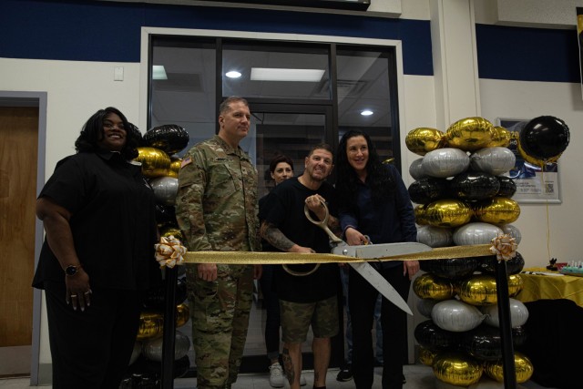 Col. Marc J. Austin, the garrison commander of Fort Stewart-Hunter Army Airfield, and Chris Schiavi, owner of Infamous Ink, cut the ribbon during a grand opening ceremony at Fort Stewart, Georgia, Jan. 31. Infamous Ink is open seven days a week...