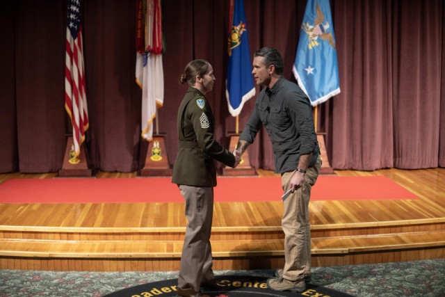 Command Sgt. Maj. Tammy Everette, Commandant of the NCO Leadership Cetner of Excellence, greets Secretary of Defense the honorable Pete Hegseth.