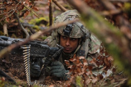 U.S. Army Pvt. Miguel Garcia, a cannon crewmember with 5-25 Charlie Battery, 3rd Brigade, 10th Mountain Division, utilizes cover and concealment to safeguard the area of operation at the Joint Multinational Readiness Center in Hohenfels, Germany, Jan. 31, 2025. Garcia and his battery are participating in exercise Combined Resolve 25-1 to field new equipment in conjunction with the Army&#39;s Transformation in Contact concept.