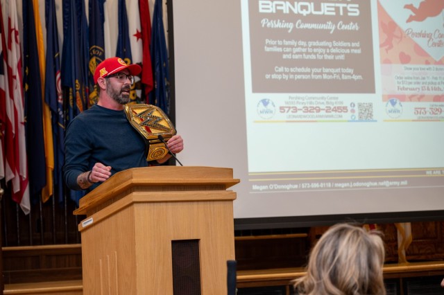 Jeffrey Barrett, the Business and Recreation chief of Fort Leonard Wood’s Family and Morale, Welfare and Recreation Directorate, dons a hat and wrestling belt to make sure everybody at the Community Information Forum Feb. 5 in Lincoln Hall...
