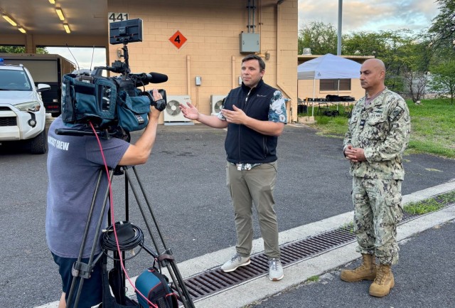 Capt. Sam White, Joint Base Pearl Harbor-Hickam commanding officer, right, is interviewed by Casey Lund, Honolulu News Now broadcast reporter, during Full-Scale Exercise Fortress Shield ‘25 Feb. 5. During the exercise, U.S. Army Garrison Hawaii, with joint partners from Joint Base Pearl Harbor-Hickam, City and County of Honolulu Department of Emergency Management, State of Hawaii Emergency Management Agency and Hawaii Department of Transportation, simulated a crisis situation on the west side of Oahu and the evacuation of motorists through Kolekole Pass. 