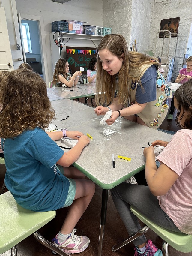 Girl Scout Katie Moen helps younger Girl Scouts with a pollinator-inspired arts and crafts project May 1, 2024, at the Girl Scouts Hastings House on Fort Leavenworth, Kansas. Photo by Amanda Moen/Volunteer helping with Katie Moen’s Gold Award...