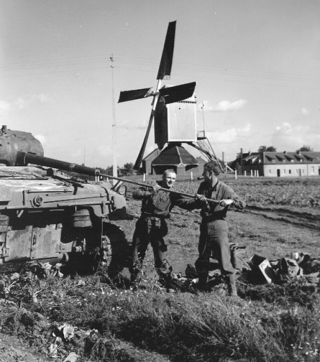 A tank crew cleaning their tank's main gun after operations in Belgium, September 1944.