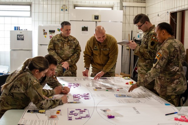 U.S. Soldiers with the Headquarters and Headquarters Company, 56th Stryker Brigade Combat Team, 28th Infantry Division, Pennsylvania National Guard in support of the Joint Multinational Training Group-Ukraine mission play through the role of medics providing treatment during a mass casualty triage wargame exercise at Grafenwoehr Training Area, Germany, Jan. 22, 2025. The wargame addresses casualty care triage in a large-scale combat operations environment. (U.S. Army National Guard photo by Capt. Leanne Demboski)