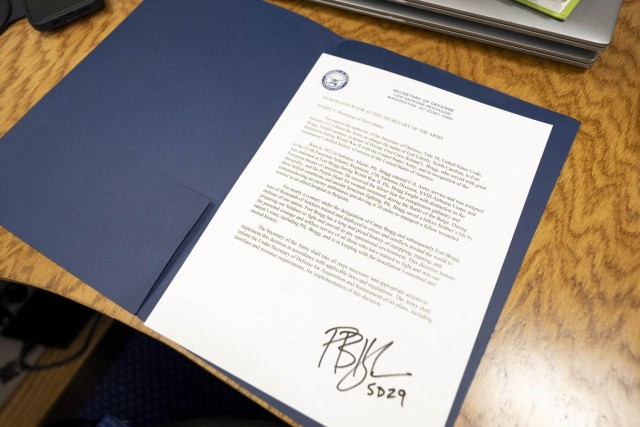 Secretary of Defense Pete Hegseth signs a memorandum reversing the name of Fort Liberty back to Fort Bragg while flying in a C-17 operated by the 300th Airlift Squadron en route to Stuttgart, Germany, Feb. 10, 2025.