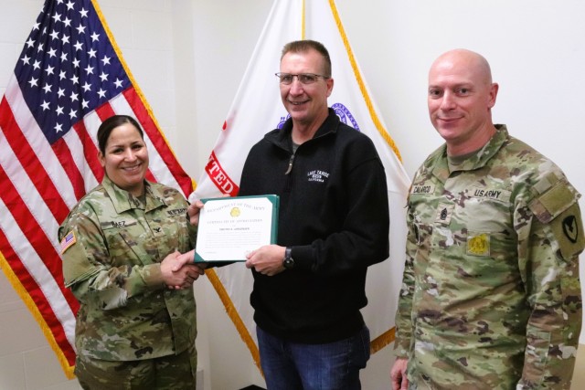 Fort McCoy Garrison Commander Col. Sheyla Baez-Ramirez presents a medal to Fort McCoy Fire Chief Timothy Jorgenson on Jan. 29, 2025, at Fire Station 1 as part of Jorgenson’s retirement ceremony at Fort McCoy, Wis. Jorgenson retired with 32 years...