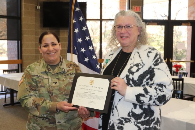 Fort McCoy Garrison Commander Col. Sheyla Baez-Ramirez completes a presentation Jan. 31, 2025, during a retirement ceremony for Fort McCoy Logistics Readiness Center employee Pamela Severson at Fort McCoy, Wis. Severson retired after serving the...
