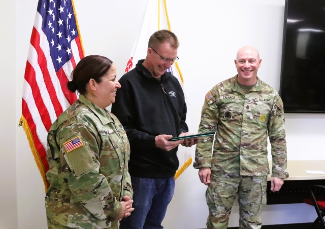 Fort McCoy Garrison Commander Col. Sheyla Baez-Ramirez presents a medal to Fort McCoy Fire Chief Timothy Jorgenson on Jan. 29, 2025, at Fire Station 1 as part of Jorgenson’s retirement ceremony at Fort McCoy, Wis. Jorgenson retired with 32 years...