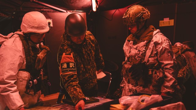 Japan Ground Self Defense Force Master Sgt. Yusuke Nakajima, a translator in the 18th Infantry Regiment, 11th Brigade, middle, and Capt. Keegan Irwin, an operations officer from Headquarters and Headquarters Company, 1st Battalion, 5th Infantry...
