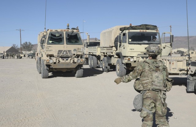 A U.S. Army Soldier assigned to 1st Infantry Division guides tactical vehicles during Rotation 25-03 at the National Training Center, Fort Irwin, Calif., Jan. 23, 2025. (U.S. Army photo by Spc. Nathan Garrett, Operations Group, National Training...