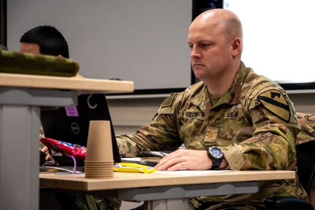 Maj. Ashley Fuqua, 1st Cavalry Division joint air ground integration center chief, works on his computer during Exercise Combined Resolve 25-1 at the Joint Multinational Readiness Center on Hohenfels Training Area, Germany, Jan. 29, 2025. Combined Resolve is a U.S.-led, NATO and partner-integrated exercise in the European theater focused on combined arms interoperability. (Parts of the image have been obscured for operational security) (U.S. Army illustration by Sgt. Jacob Nunnenkamp)