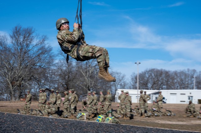 Pvt. Riderigo Ramos, a trainee with Company C, 3rd Battalion, 10th Infantry Regiment, 3rd Chemical Brigade, comes to a stop at the bottom of the Slide for Life obstacle Feb. 3 at Training Area 97.