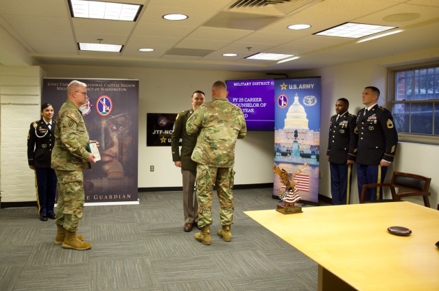 Sgt. 1st Class Stephen Hughes is presented with a certificate, pin and trophy after competing in the 2025 Career Counselor of the Year competition at the U.S. Army Military District of Washington. Hughes will compete in a similar competition at...