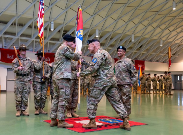 Incoming 1st Engineer Brigade Command Sgt. Maj. Jesse Cody (left) accepts the brigade flag from Col. Mark Glaspell (center), the brigade commander, as outgoing brigade Command Sgt. Maj. Don Batchan (right) looks on during a...