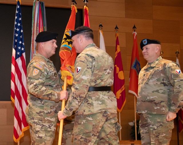 Soldiers pass the U.S. Army Communications-Electronics Command flag during a change of responsibility ceremony.