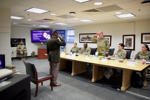 Staff Sgt. Donovan Glasgow salutes Command Sergeant Major Vern Daley at the start of the formal board portion of the U.S. Army Military District of Washington’s Career Counselor of the Year competition. The competition takes place over two days...