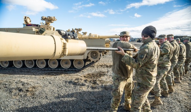 Tankers from Bravo Company, 3rd Battalion, 116th Cavalry Regiment, Oregon Army National Guard, conduct maintenance by cleaning the main gun tube of their M1A2 SEP v2 Abrams tank during an Inactive Duty Training (IDT) weekend at Raymond F. Rees Training Center in Umatilla, Oregon, Feb. 1, 2025. The IDT weekend marked the first use of the center&#39;s new six-mile tank trail, providing local tank crews with essential driver training capabilities without traveling to out-of-state facilities.
