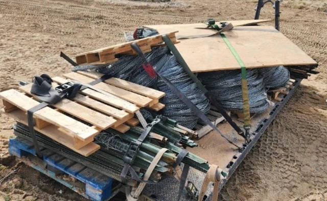 Poorly built CCL loaded with concertina wire, pickets, and barbed wire. Note the concertina wire falling over and randomly placed rachet straps.