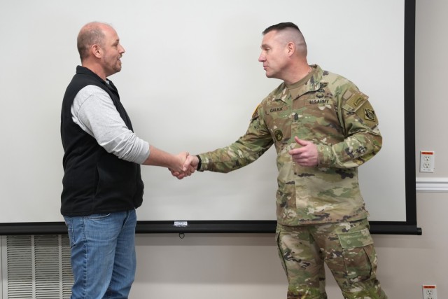 U.S. Army Corps of Engineers Command Sergeant Major Douglas Galick (right) presents his coin to Travis Little, Center Hill Civil Engineering technician, in recognition of Little’s hard work and professionalism in carrying out the U.S. Army Corps...