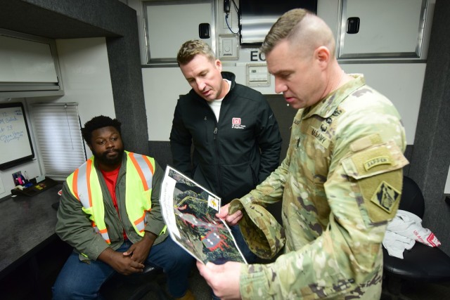 Adam Gaskin (Center), team leader for public works and engineering, shows U.S. Army Corps of Engineers Command Sgt. Maj. Douglas Galick a map of Douglas Lake in Dandridge, Tennessee, where USACE is providing technical assistance to Tennessee...