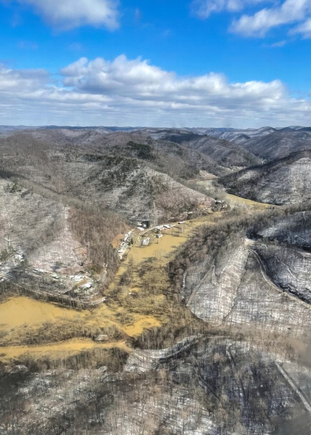 Airmen and Soldiers from the Kentucky National Guard prepare to land at a housing complex surrounded by floodwaters in Martin County, Kentucky, Feb. 17, 2025, to evacuate stranded residents. The troops, including Airmen from the Kentucky Air...