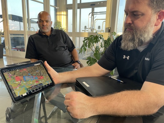 Richard Pahnke (foreground), a Leidos pilot assigned to the Army Geospatial Center&#39;s BuckEye program, reviews a flight plan as copilot Reginald Williams looks on, Feb. 2, 2025, at Burbank Airport in Los Angeles.
...