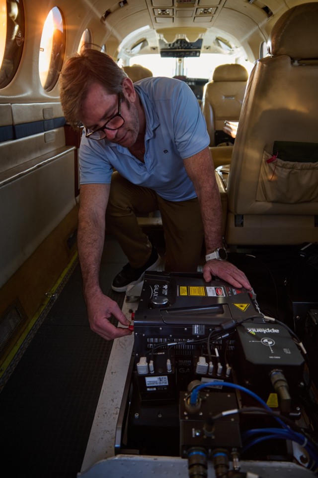 Mark &#34;Shep&#34; Szypula, a Leidos contractor and sensor operator assigned to the Army Geospatial Center&#39;s BuckEye program, checks the aircraft&#39;s array of camera and LIDAR sensors, Feb. 2, 2025, at Burbank Airport in Los Angeles...