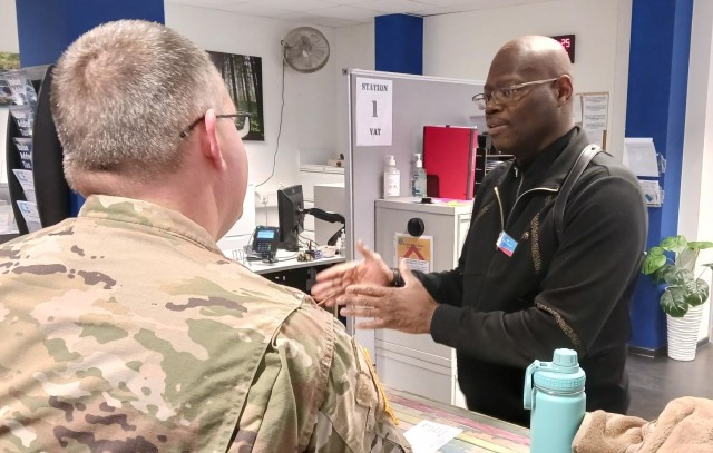 Value Added Tax Office Clerk Jon Lacy with U.S. Army Garrison Wiesbaden explains the VAT App program to a new customer.