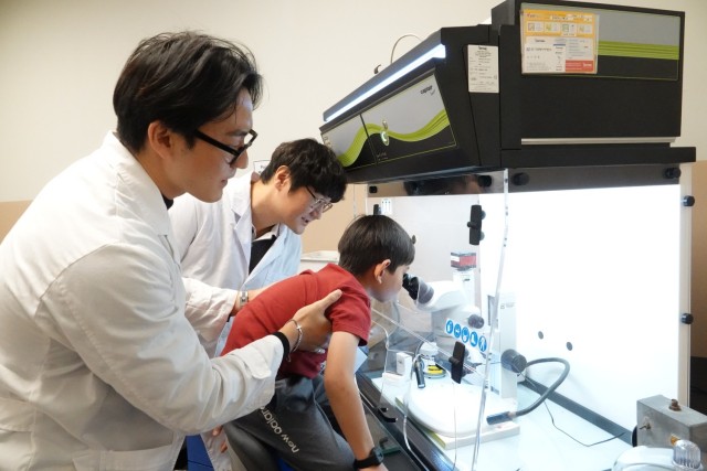 USACE FED employee with children in lab