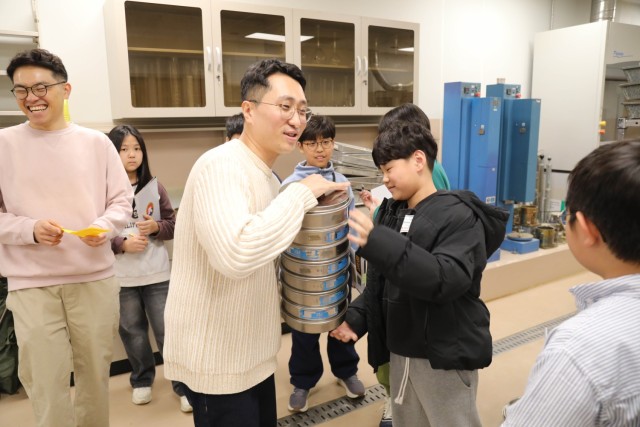 USACE FED employee with children in lab